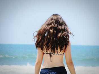 Rear view of a woman against the sea