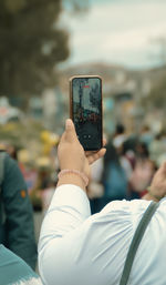 Low section of woman using mobile phone