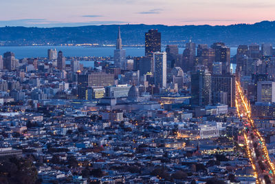 Aerial view of illuminated cityscape against sky