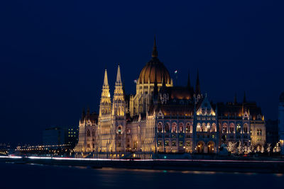 Illuminated building against sky at night