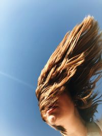 Portrait of teenage girl against clear sky