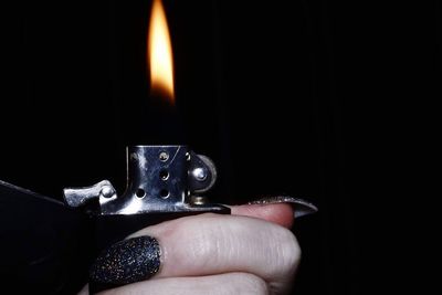 Close-up of human hand against black background