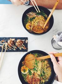 High angle view of person holding food on table