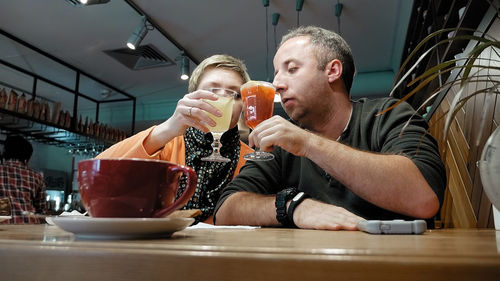 Low angle view of friends having drinks in restaurant