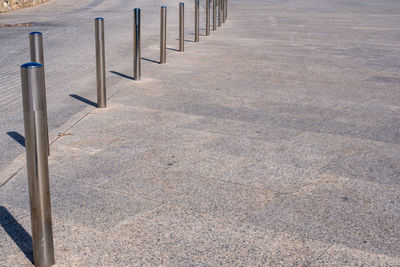 High angle view of metal fence on footpath