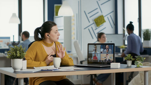 Businesswoman using laptop at office