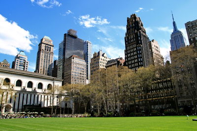 Buildings in city against cloudy sky