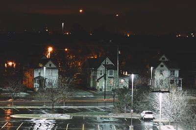 Illuminated city against sky at night