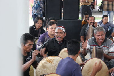 Young couple looking at people sitting in room