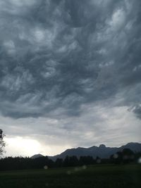 Scenic view of mountains against cloudy sky