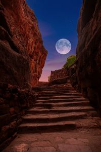 Low angle view of rock formation against sky at night