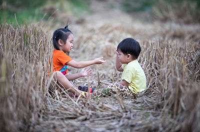 Side view of father and son on land