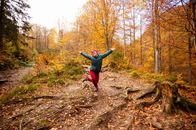 Woman standing in forest