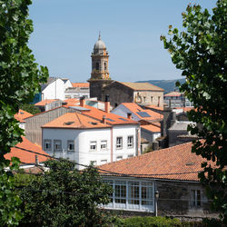 View of buildings and trees against sky