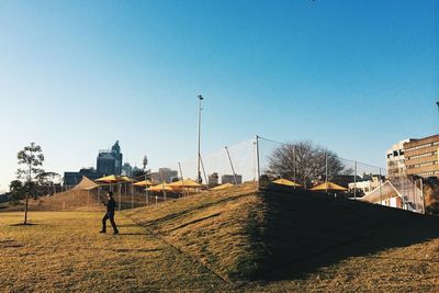Buildings against clear blue sky