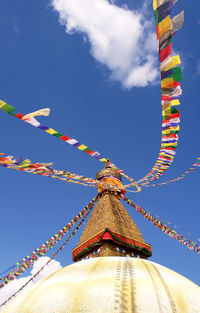 Low angle view of multi colored flags against sky
