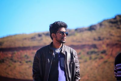 Portrait of young man standing outdoors