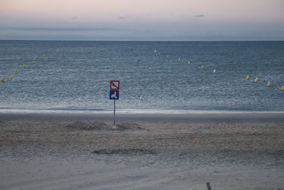 Scenic view of beach against sky during sunset