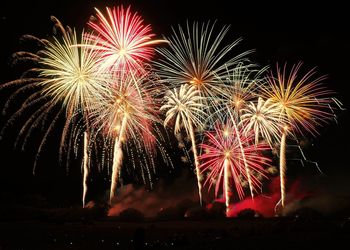 Low angle view of firework display at night