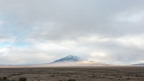 Scenic view of mountains against cloudy sky