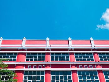 Low angle view of siola building in surabaya against blue sky