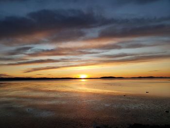 Scenic view of beach against sky during sunset