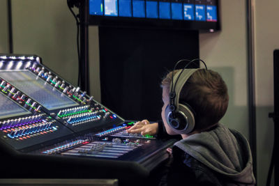Close-up of boy using sound mixer in studio