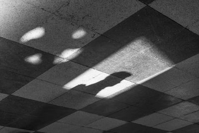 Shadow of person on tiled floor