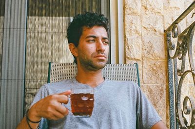 Man having drink in balcony