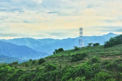 Scenic view of mountains against cloudy sky