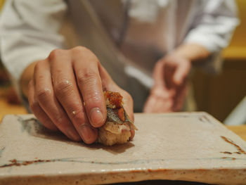 Midsection of person preparing food on table