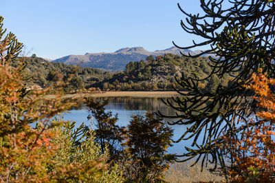 Scenic view of lake and mountains against clear sky