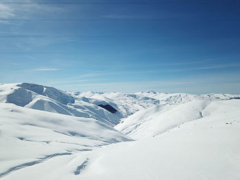 Scenic view of snow covered mountains against sky