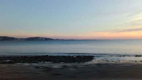 Scenic view of sea against sky at sunset