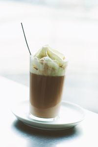 Close-up of hot chocolate with whipped cream against white background