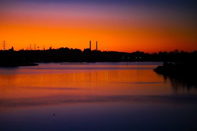 Scenic view of lake against romantic sky at sunset