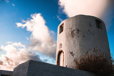 Low angle view of building against cloudy sky