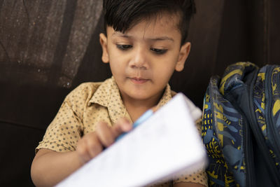 Close-up of cute boy studying at home