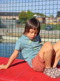 Full length of young child against the fence