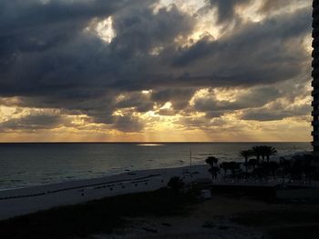 Scenic view of beach against dramatic sky