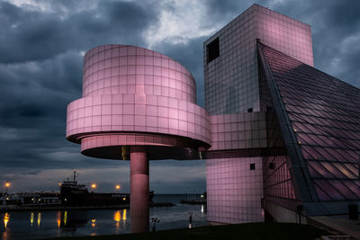 Low angle view of modern building against cloudy sky