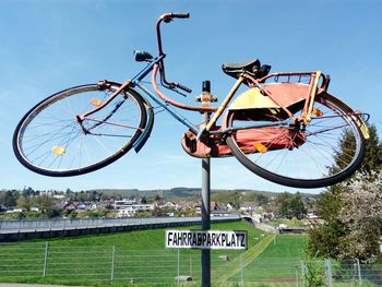 Low angle view of bicycle sign on pole