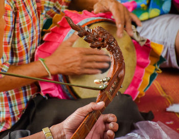 Midsection of artists playing musical instrument 