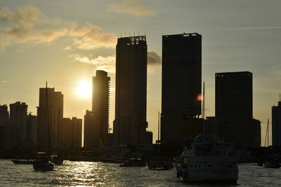 View of skyscrapers in city at sunset