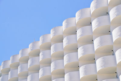 Low angle view of white hotel building against blue sky, cala d'or, mallorca
