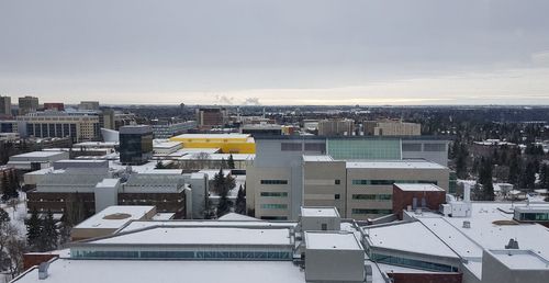 High angle view of buildings in city against sky