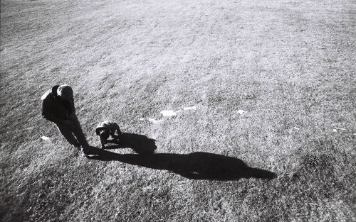 High angle view of people shadow on water