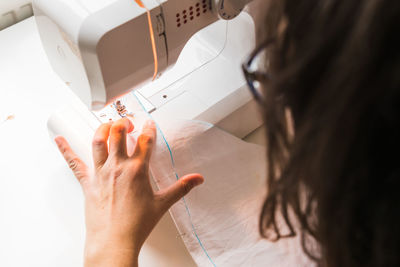 Midsection of woman using mobile phone at home