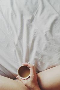 Human hand holding tea cup