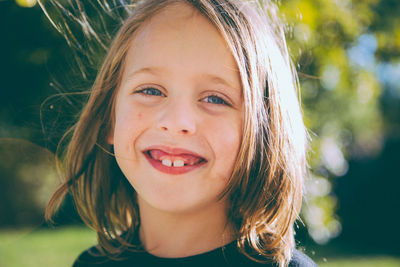 Portrait of smiling boy against trees